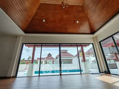 Luxurious villa with high wooden ceiling and pool view