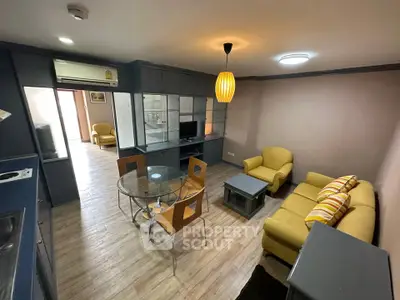 Modern living room with yellow sofas and glass dining table in stylish apartment