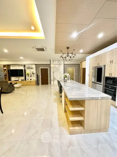 Luxurious open-plan kitchen with marble countertops and modern appliances