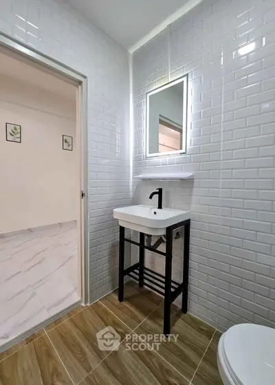 Modern bathroom with sleek white tiles and stylish vanity in a contemporary home.