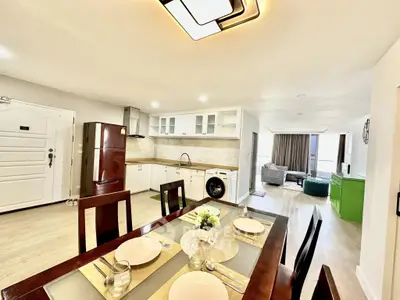 Spacious open-plan kitchen and dining area with modern appliances and elegant decor.