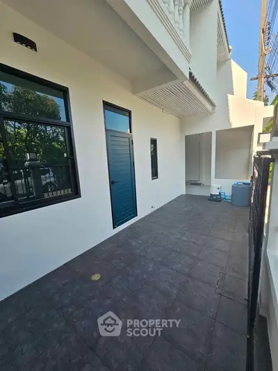 Modern exterior patio with sleek tiles and contemporary design, perfect for outdoor relaxation.