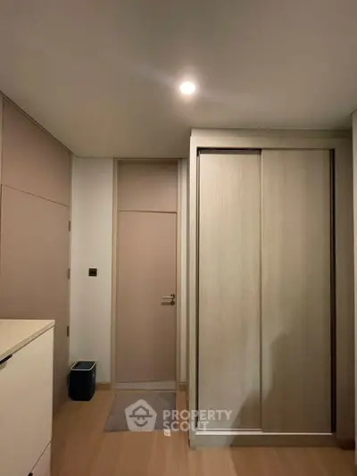 Modern bedroom with sleek wooden wardrobe and minimalist design