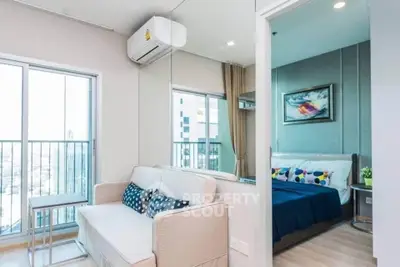 Modern apartment interior with cozy living room and stylish bedroom, featuring large windows and contemporary decor.