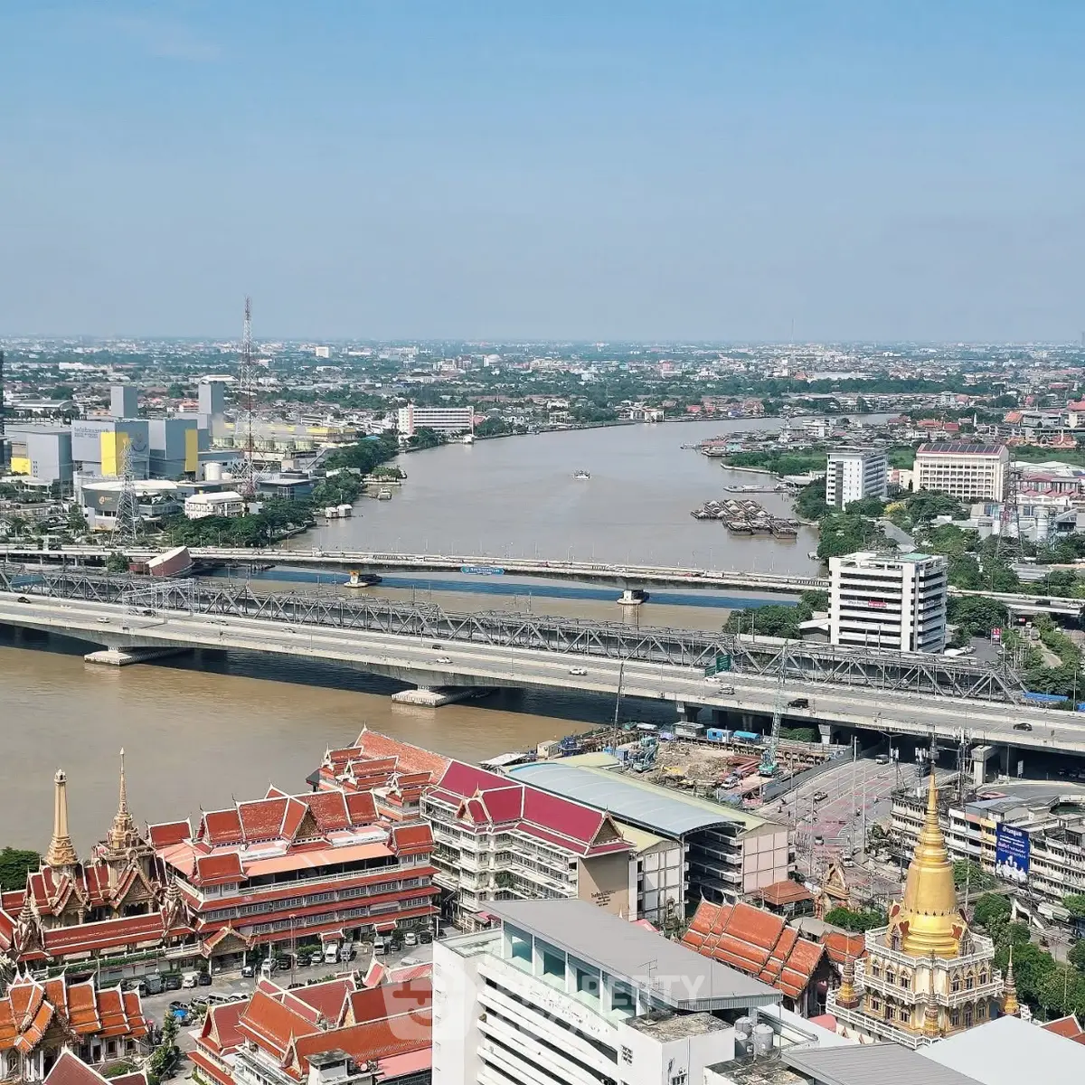 Stunning aerial view of a vibrant cityscape with river and iconic architecture, perfect for urban living enthusiasts.