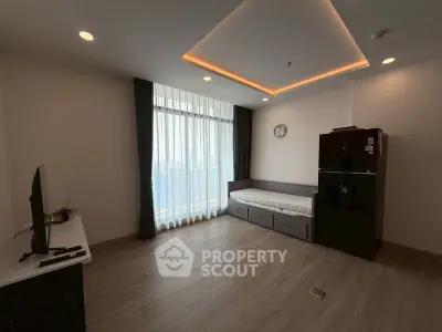 Modern living room with large window and sleek furniture