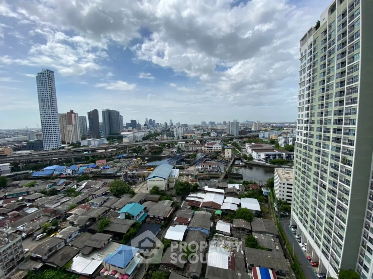 Stunning cityscape view from high-rise building showcasing urban skyline and residential area.