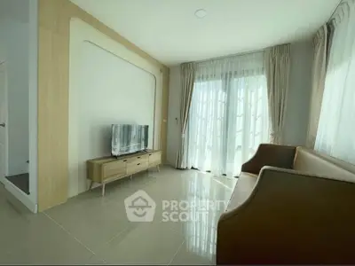 Bright and modern living room with sleek furniture and large windows for natural light.