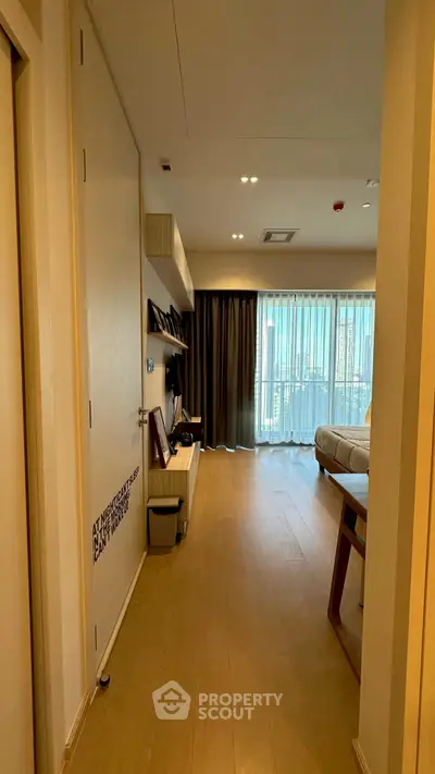 Modern living room with wooden flooring and large window for natural light