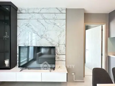 Modern living room with marble accent wall and sleek TV setup, perfect for stylish urban living.