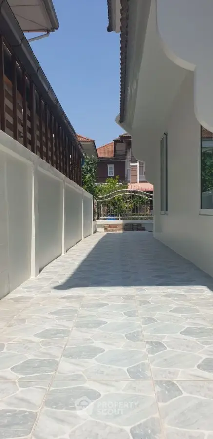 Charming exterior walkway with tiled path and modern architecture
