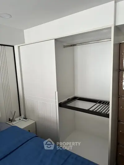 Modern bedroom with open closet and sleek design