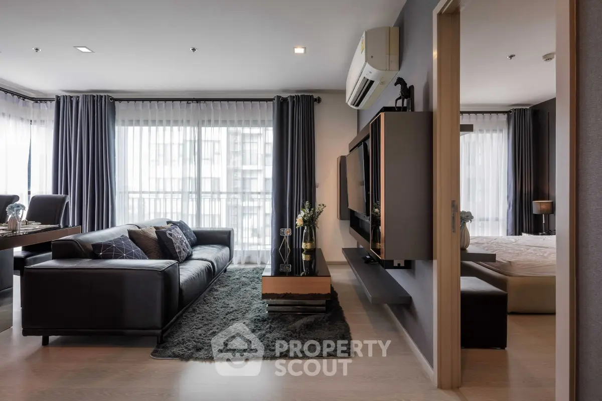 Luxurious modern living room with sleek design and large windows in a high-end apartment.