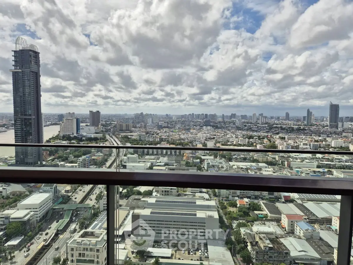 Stunning cityscape view from a high-rise balcony showcasing urban skyline and expansive horizon.