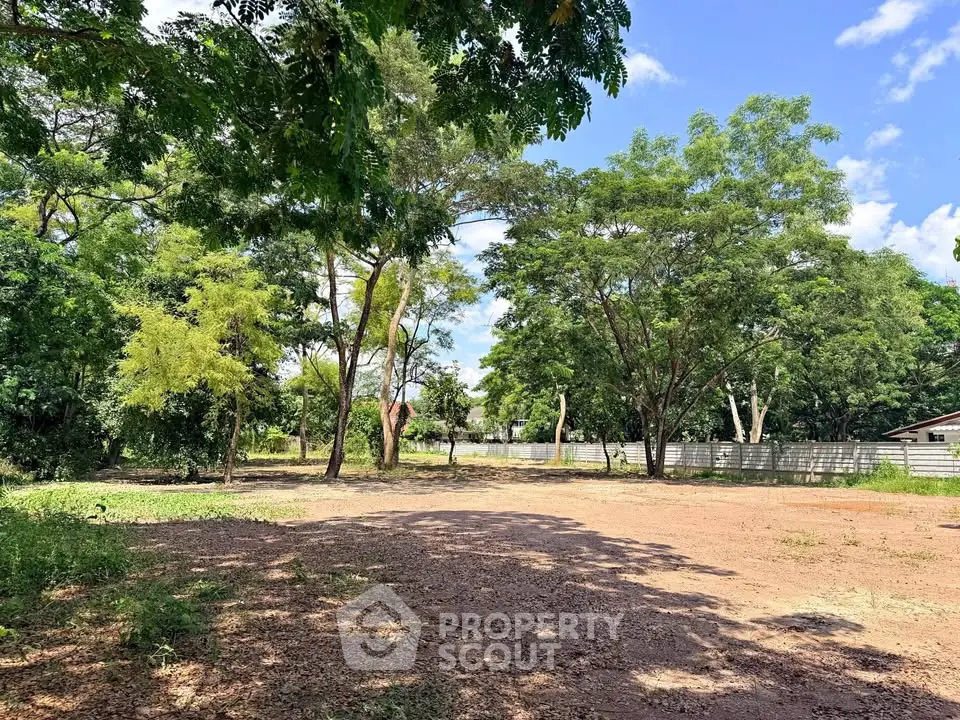 Spacious vacant land surrounded by lush greenery, perfect for development opportunities.