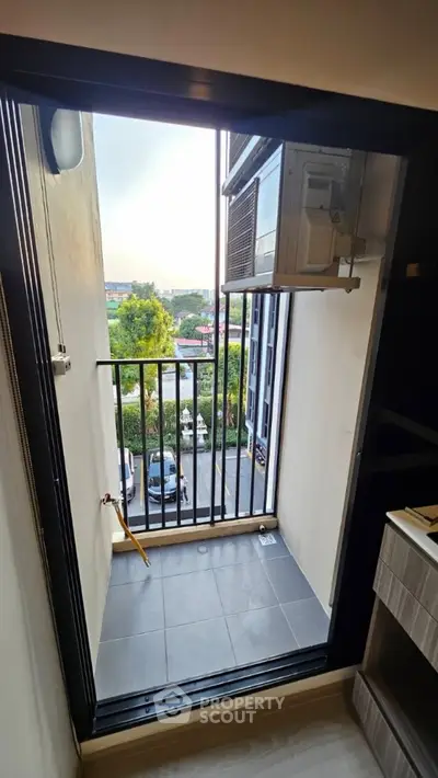 Compact balcony with air conditioning unit and scenic view in modern apartment