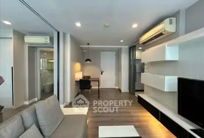 Modern living room with sleek furniture and air conditioning in a stylish apartment.