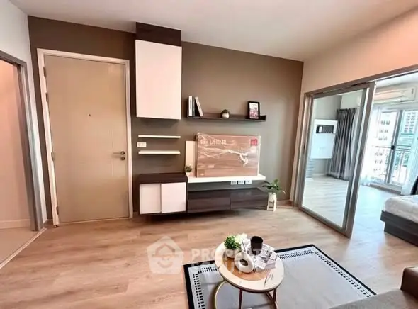 Modern living room with stylish decor and open layout, featuring wooden flooring and contemporary furniture.