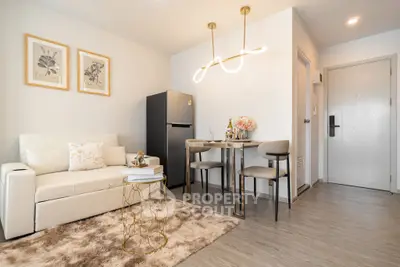 Modern living room with stylish decor and dining area in a cozy apartment.