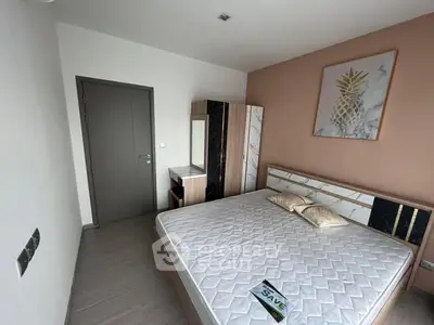 Modern bedroom with stylish decor and comfortable bed in real estate property.