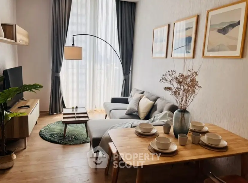 Stylish living room with modern decor, cozy sofa, and elegant dining setup.