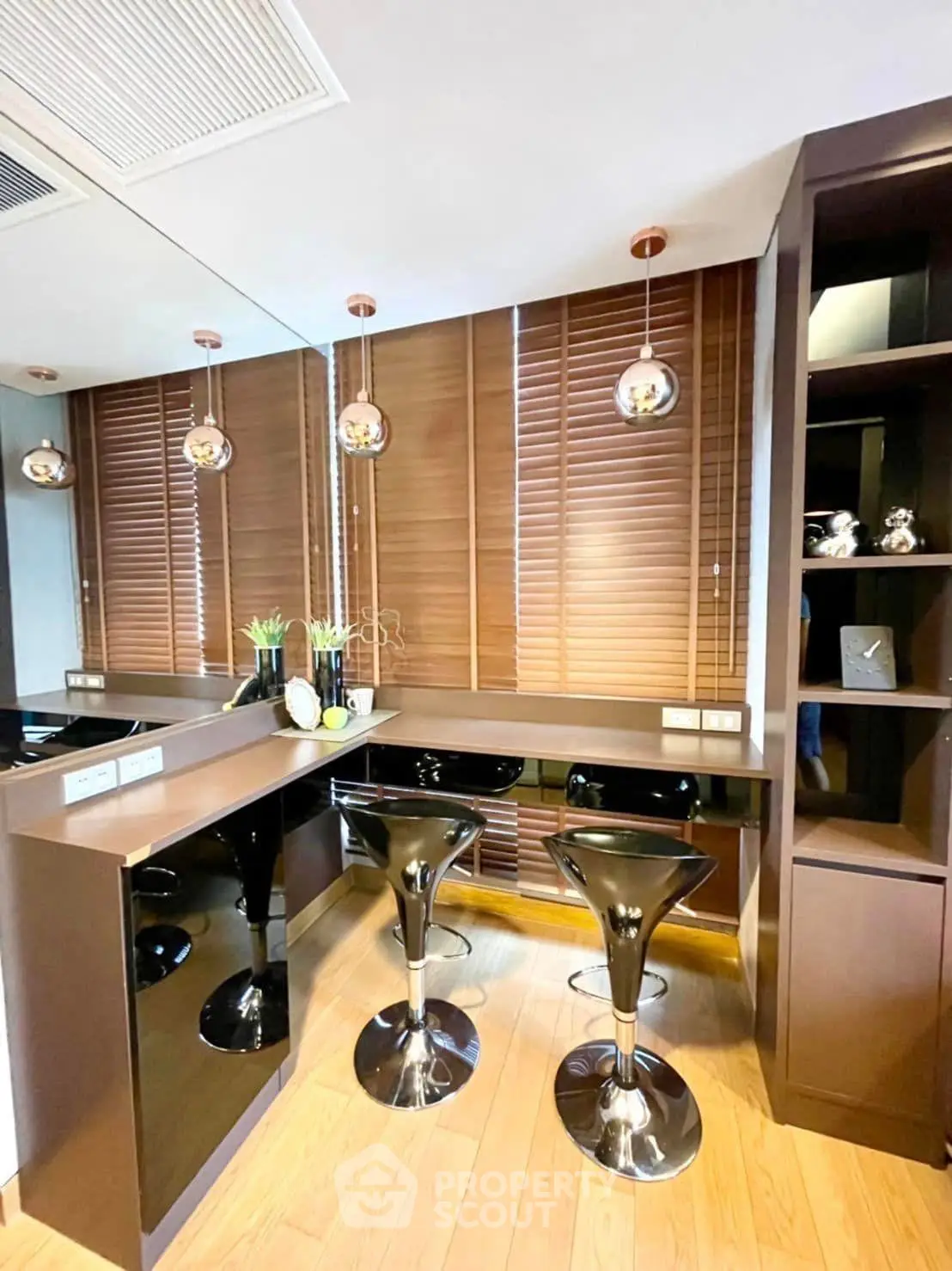 Modern study area with sleek black chairs and wooden blinds in a stylish apartment.