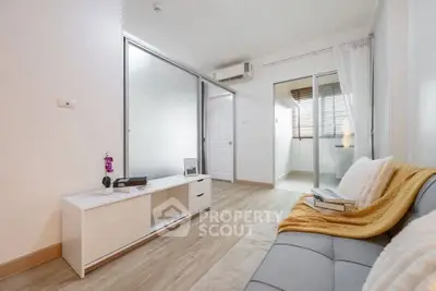 Modern living room with sleek design and natural light, featuring a cozy sofa and stylish decor.
