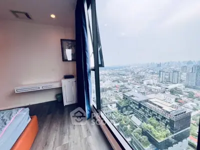 Stunning high-rise bedroom with panoramic city view, modern decor, and floor-to-ceiling windows.