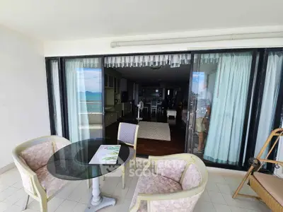 Spacious balcony with ocean view and stylish outdoor seating