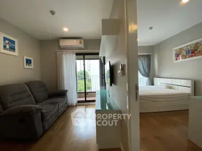 Modern living room with balcony and bedroom view in stylish apartment