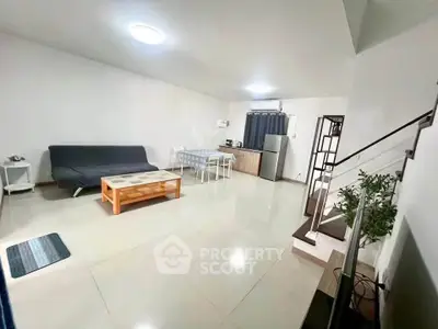 Spacious living room with modern furniture and open layout in a stylish apartment.
