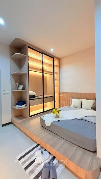 Modern bedroom with built-in wardrobe and cozy platform bed