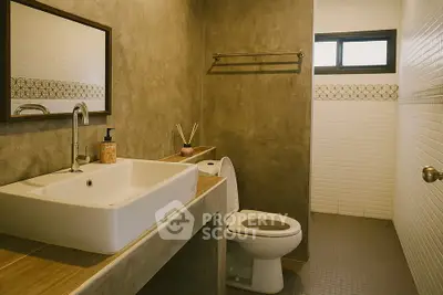 Modern bathroom with stylish sink and toilet in a contemporary home.