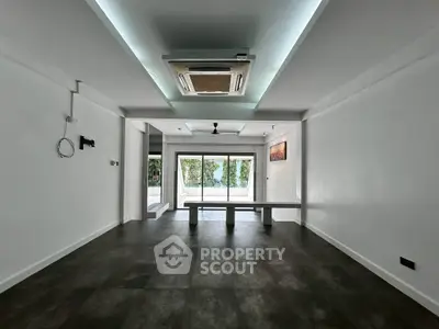 Spacious modern living room with sleek flooring and large windows