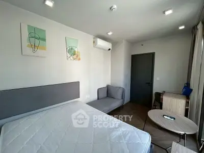 Modern bedroom with stylish decor and air conditioning in a contemporary apartment.