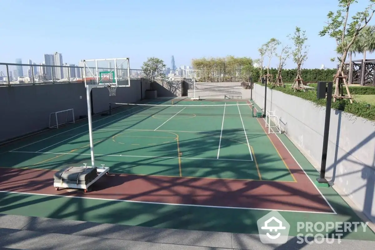 Spacious rooftop basketball court with city skyline view, perfect for sports enthusiasts and urban living.