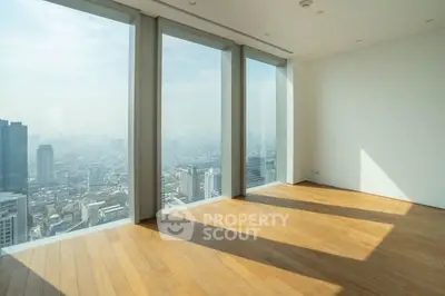 Spacious corner unit with panoramic city views and floor-to-ceiling windows.