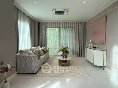 Elegant living room with modern decor and large windows for natural light.