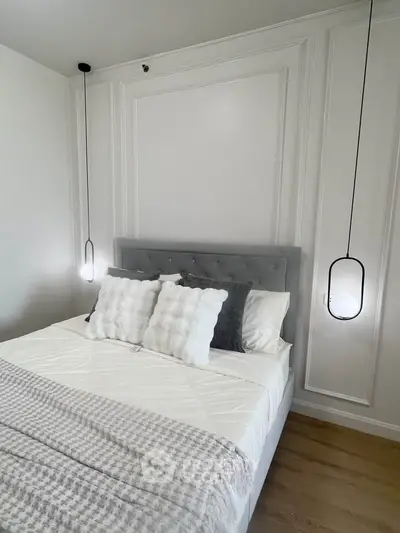 Elegant bedroom with modern lighting and plush bedding