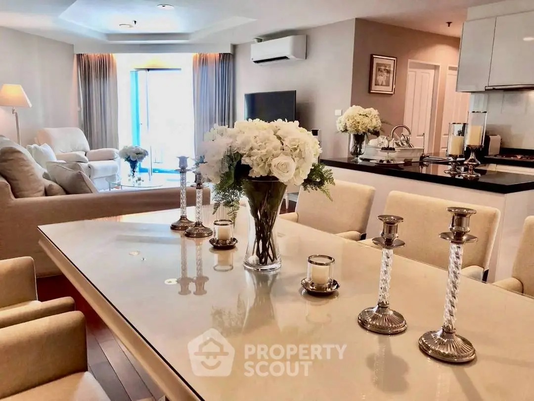 Luxurious open-plan living and dining area with elegant decor and abundant natural light.