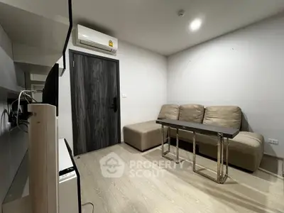 Modern living room with sleek furniture and air conditioning, perfect for cozy urban living.