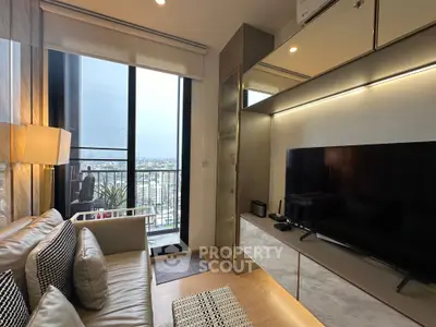Modern living room with balcony view, sleek TV setup, and cozy seating area in a high-rise apartment.