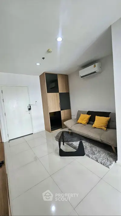 Modern living room with sleek furniture and air conditioning in a stylish apartment.
