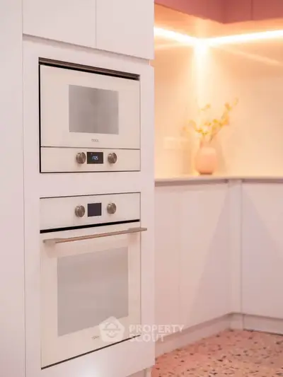 Modern kitchen with built-in ovens and stylish lighting