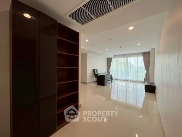 Spacious modern living room with large windows and sleek furniture