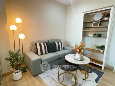 Charming living room with cozy sofa, stylish shelving, and elegant decor in modern apartment.