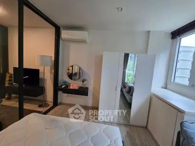 Modern bedroom with large mirror and natural light