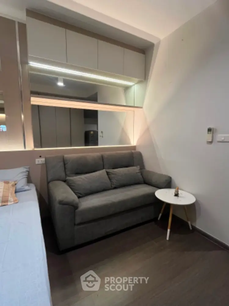 Modern living room with stylish gray sofa and sleek wall cabinet