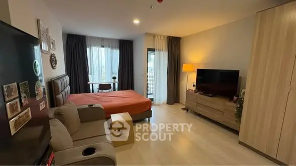 Modern studio apartment with cozy living area and large window view