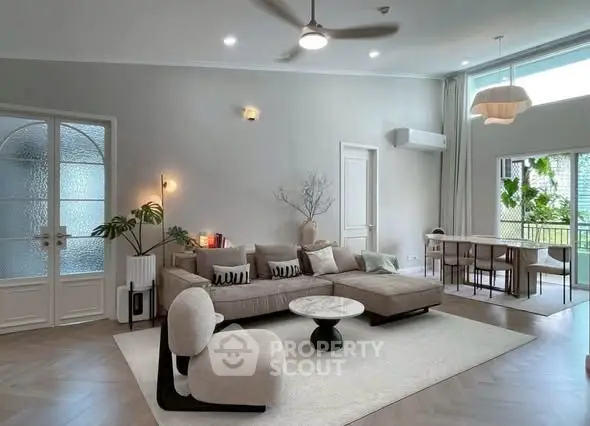Spacious modern living room with elegant decor and large windows for natural light.